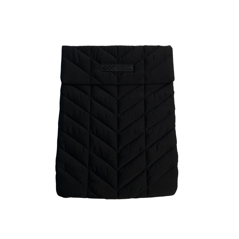 Black quilted product with a brand label on a white background